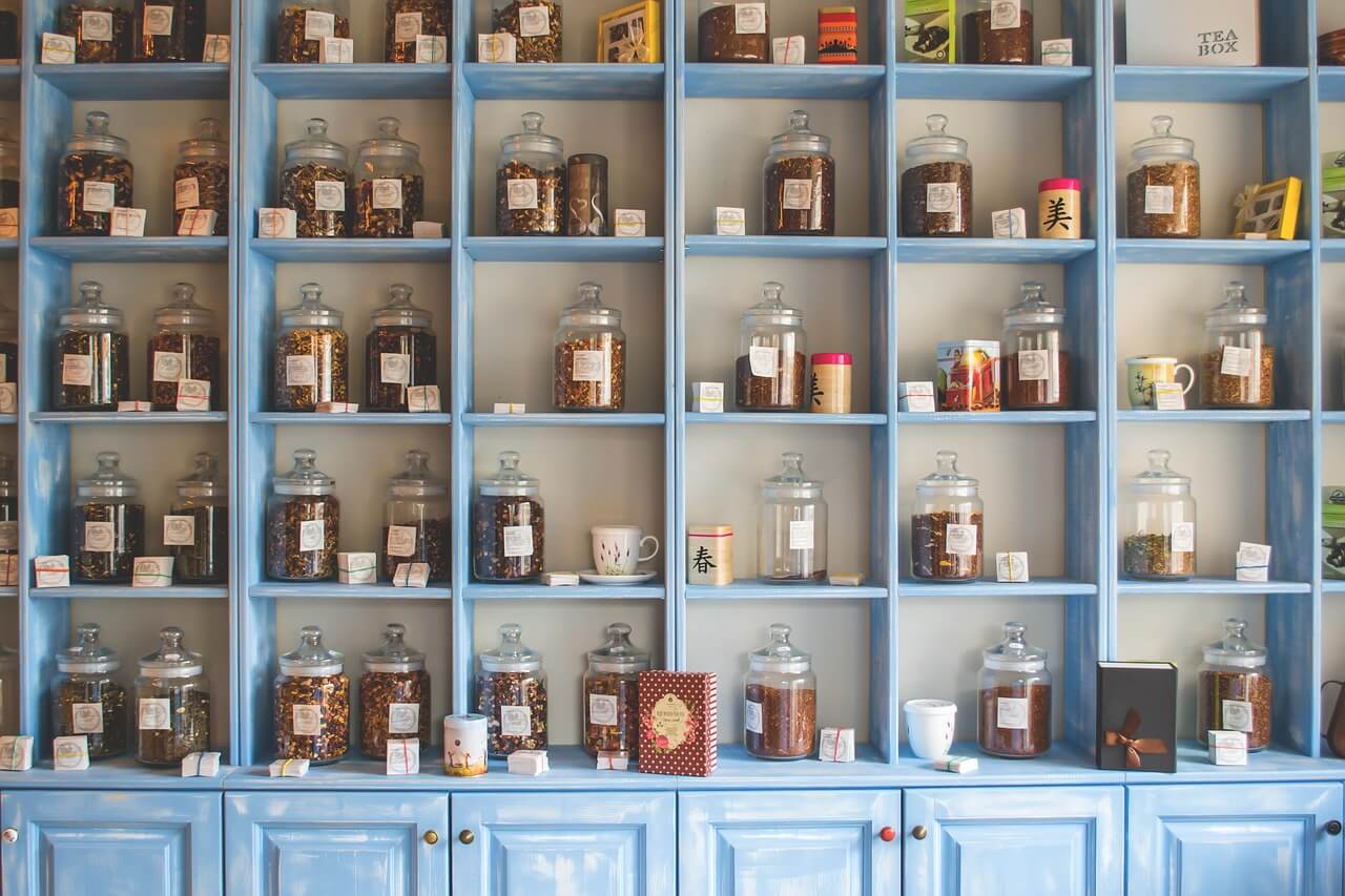 Understanding herbal terminology - shelves with different jars with herbs in them.